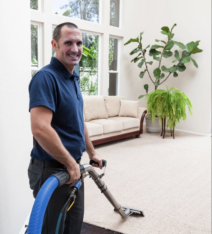 A steam-cleaning professional deep-cleaning a living-room carpet